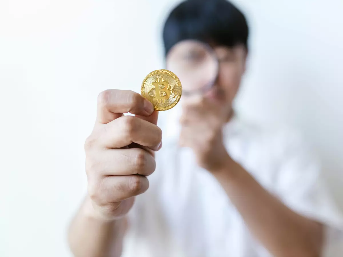 A close-up shot of a pile of crypto coins on a red surface. 